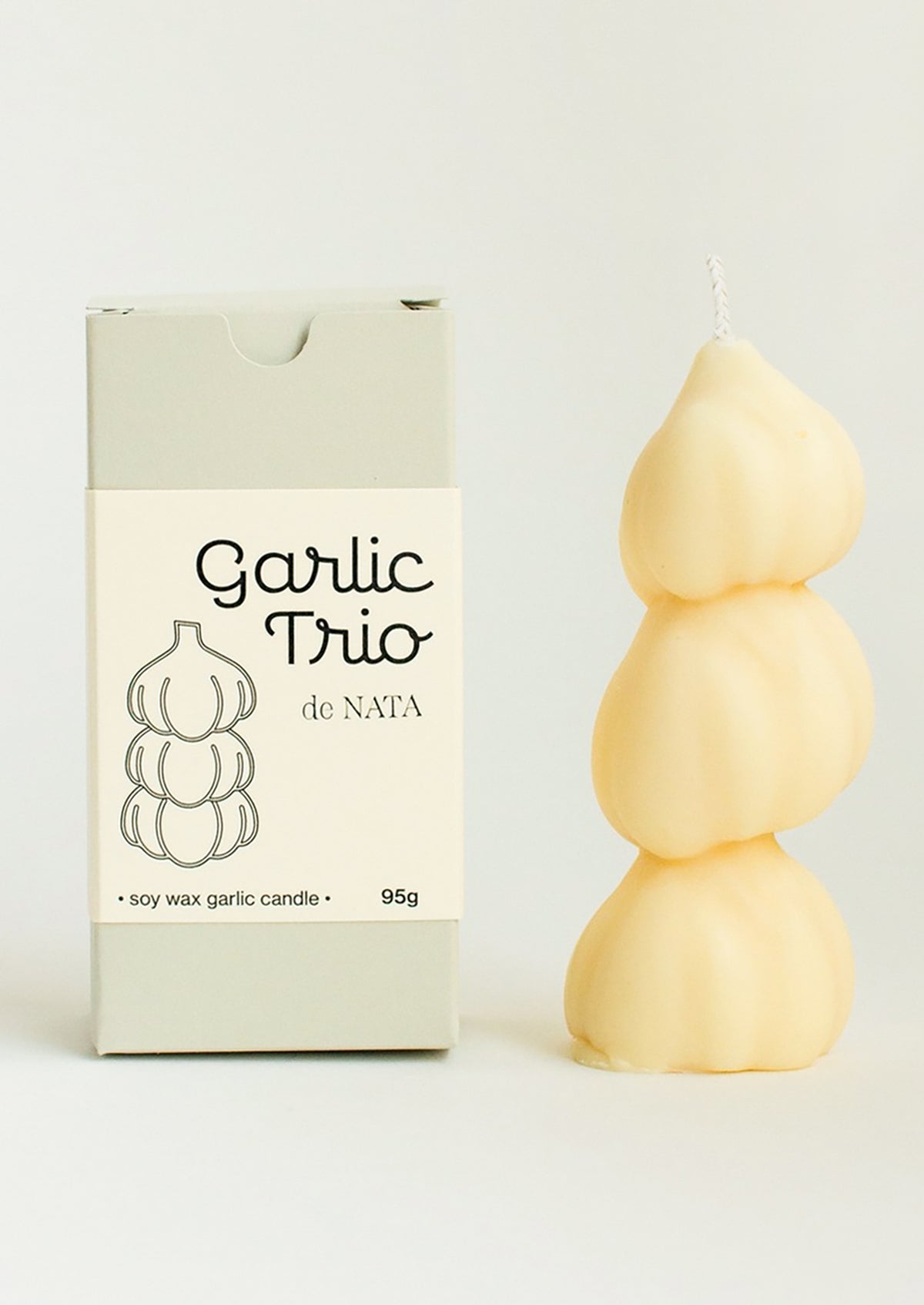 A candle in the shape of three stacked garlic bulbs.