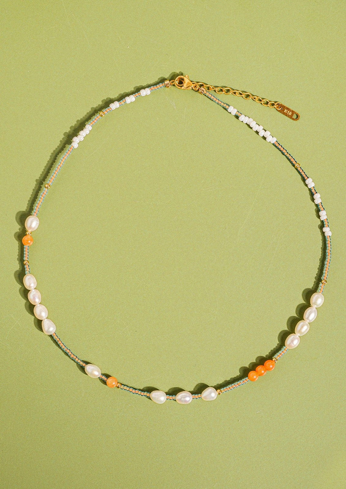 Necklace with beads on a green background