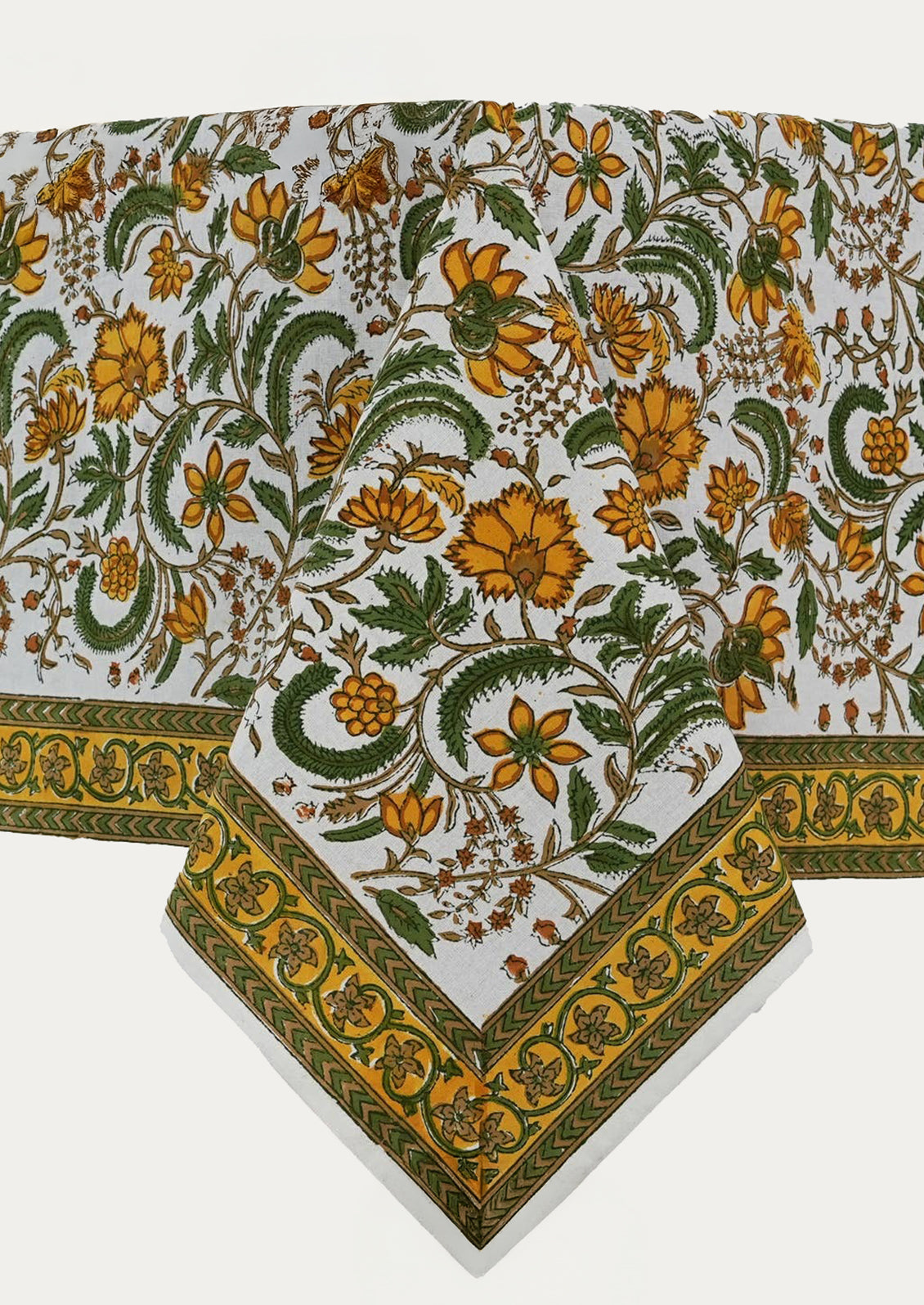 A block printed tablecloth in yellow and green floral pattern.