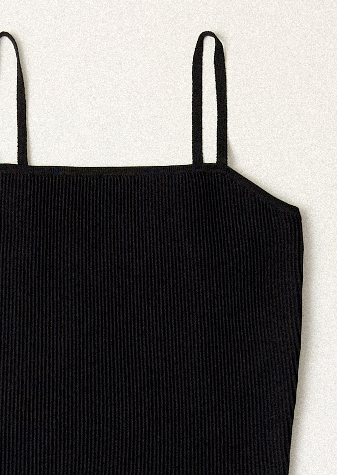 A black spaghetti strap dress with fitted bodice.