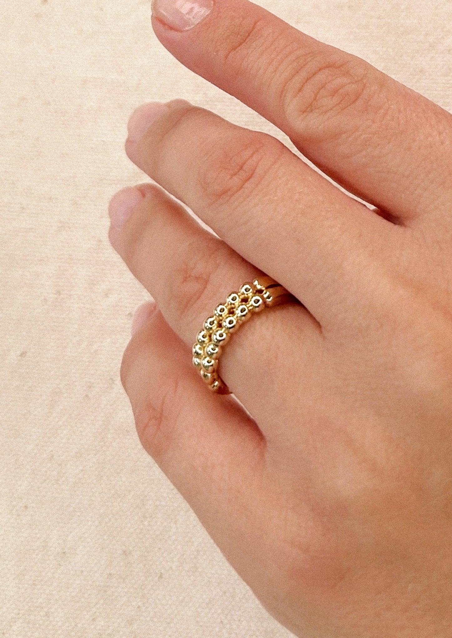 A gold ring with look of double beaded band.