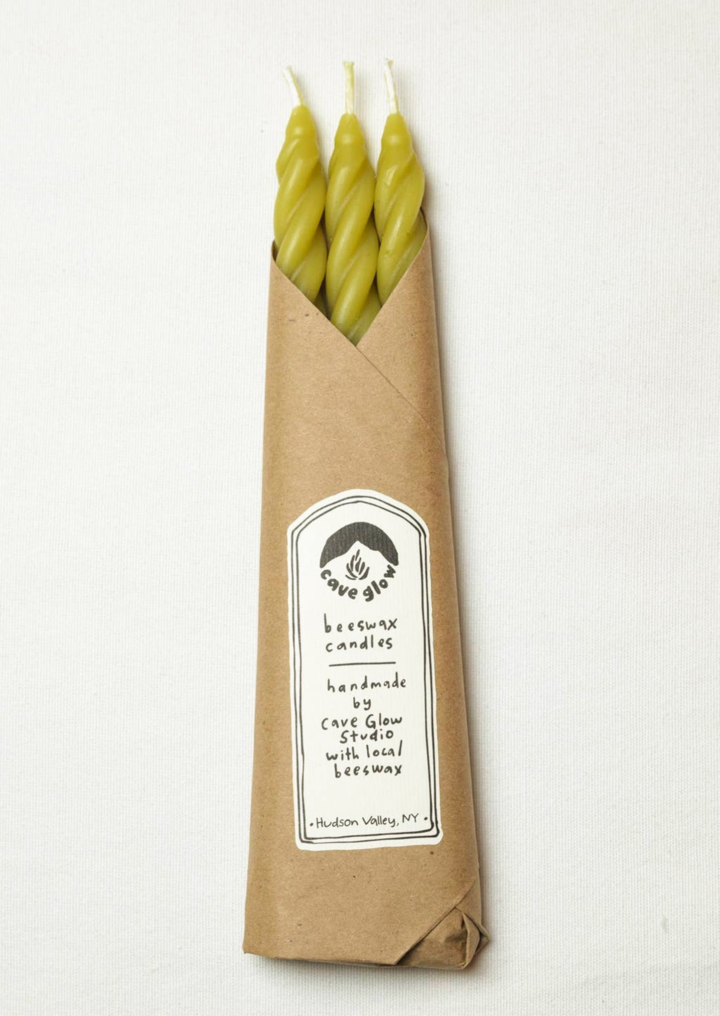 A set of three spiral textured taper candles in chartreuse color.
