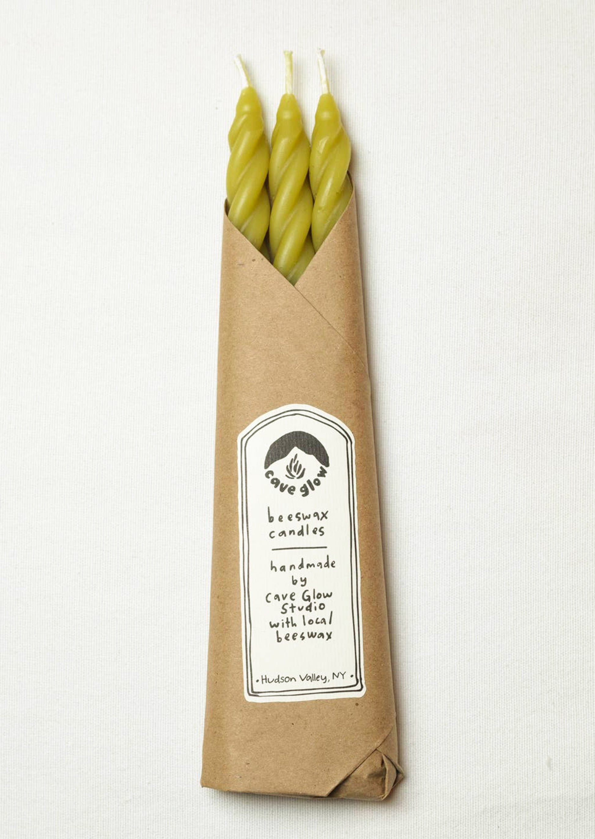 A set of three spiral textured taper candles in chartreuse color.