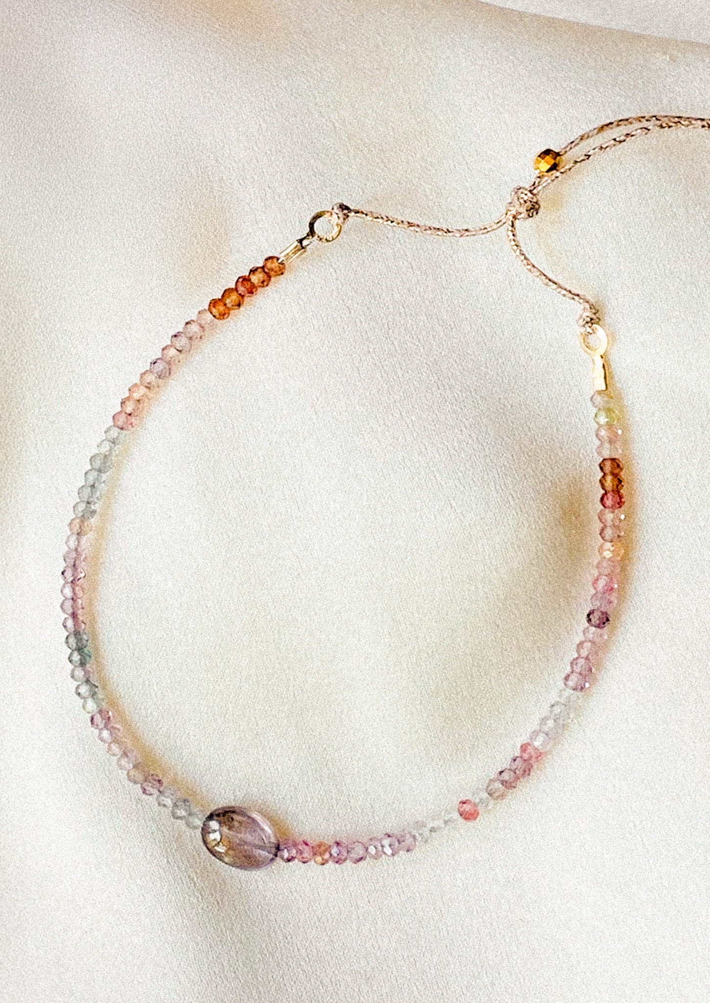 A beaded bracelet in spinel gemstones in purple tones.