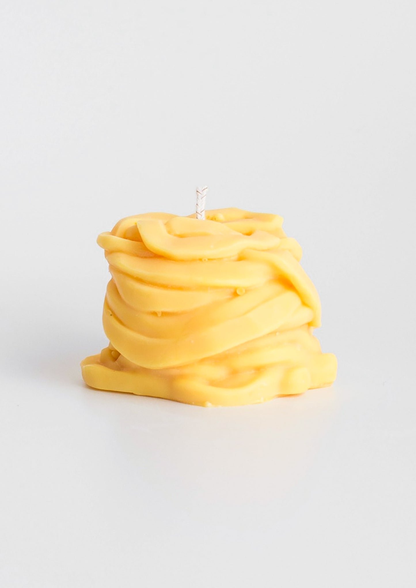 A candle in the shape of a piece of tagliatelle pasta.