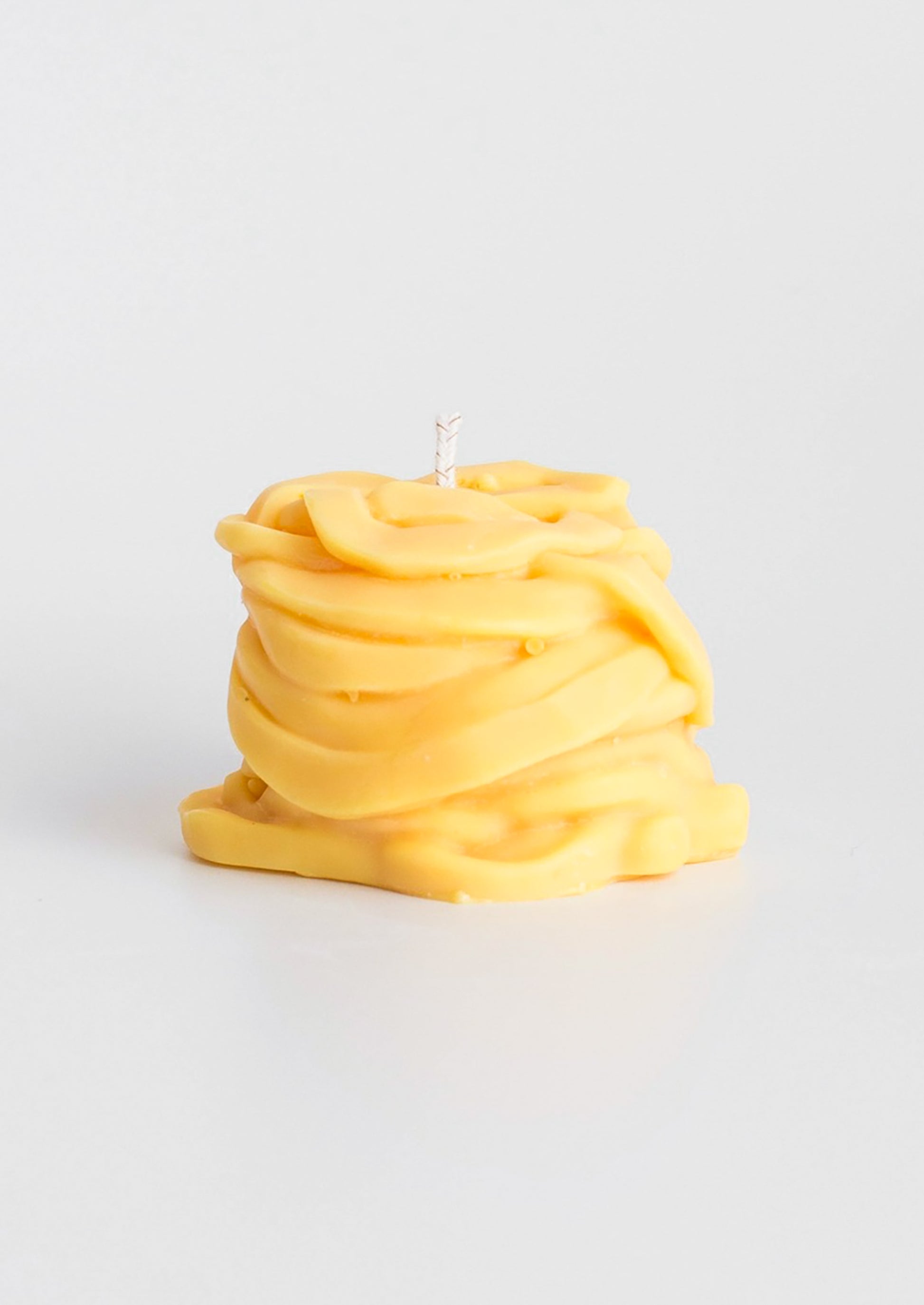 A candle in the shape of a piece of tagliatelle pasta.