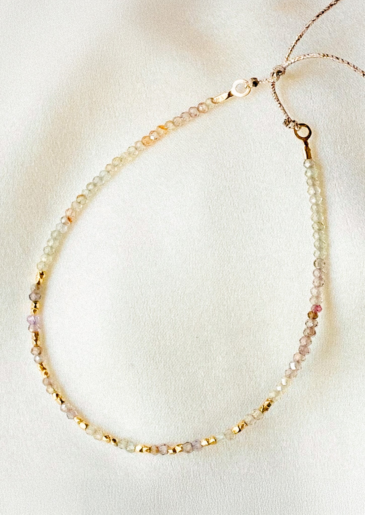 A beaded bracelet in spinel gemstones in purple tones.