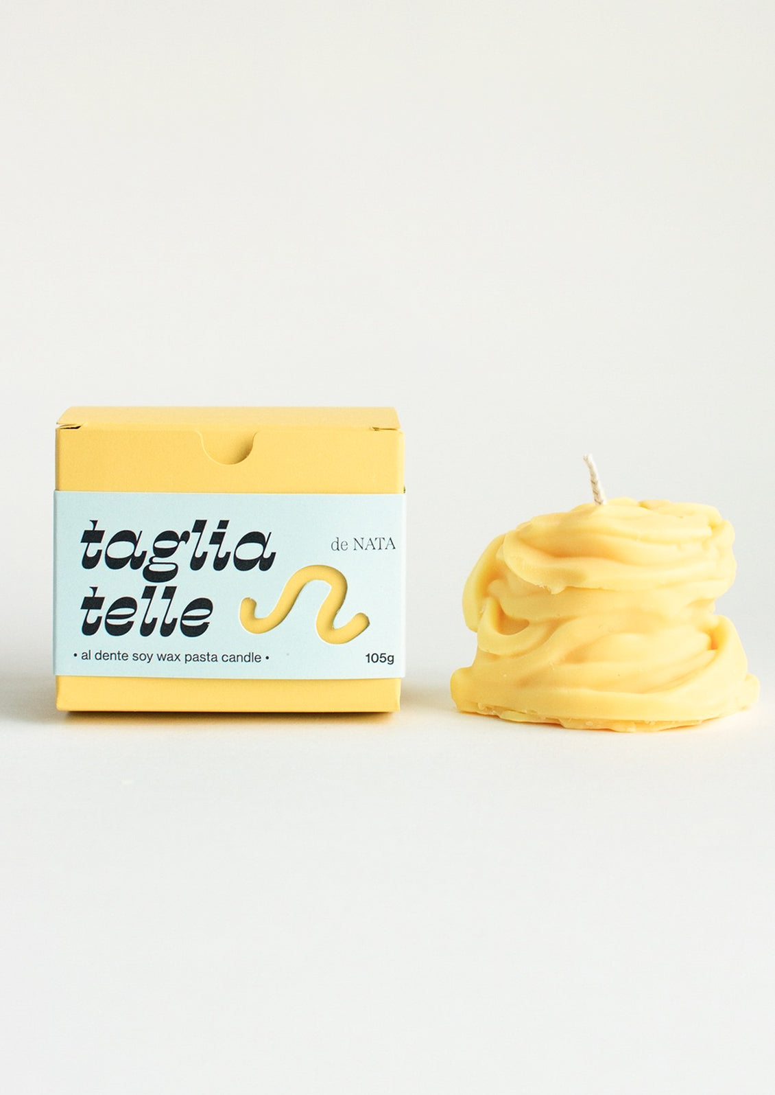 A candle in the shape of a piece of tagliatelle pasta.