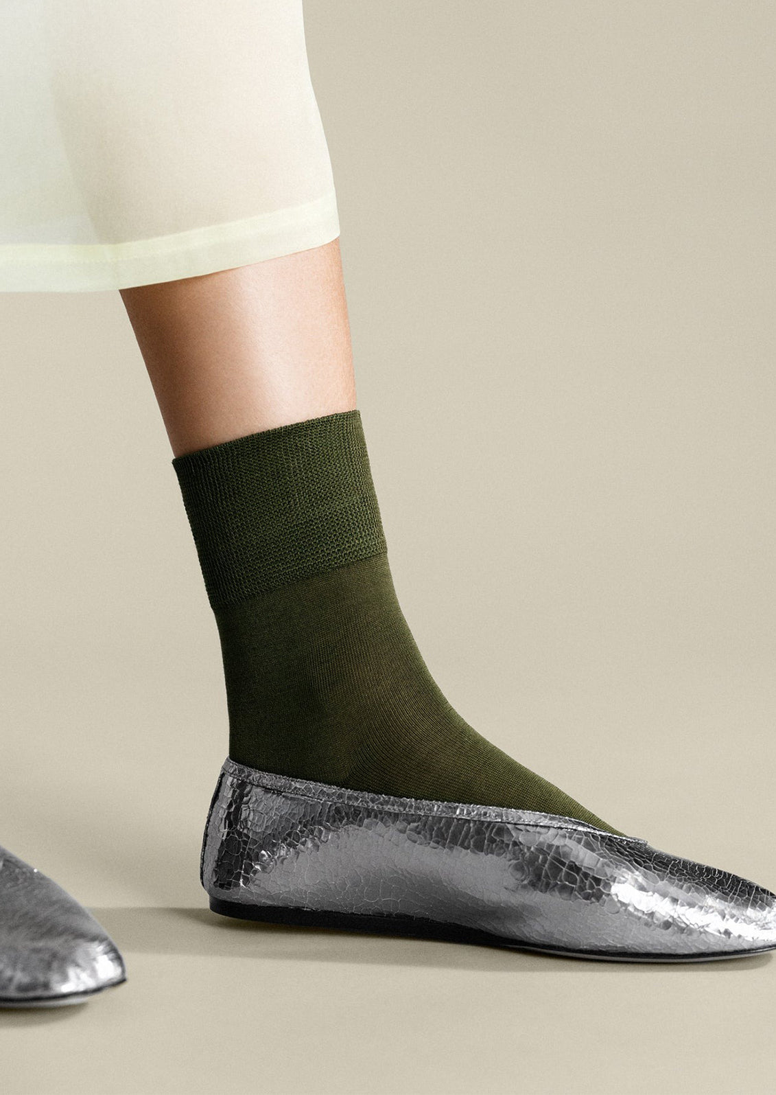 A pair of classic socks in moss green.