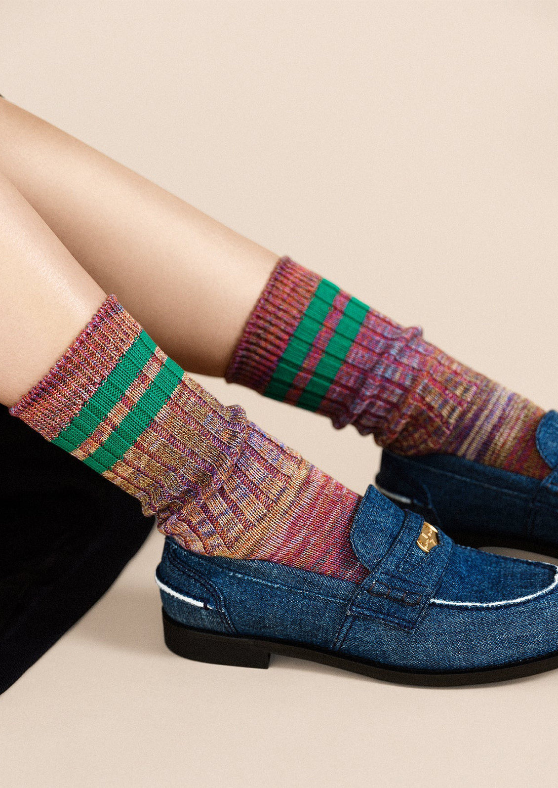 A pair of multicolor space dye socks with double green sporty stripe detail.