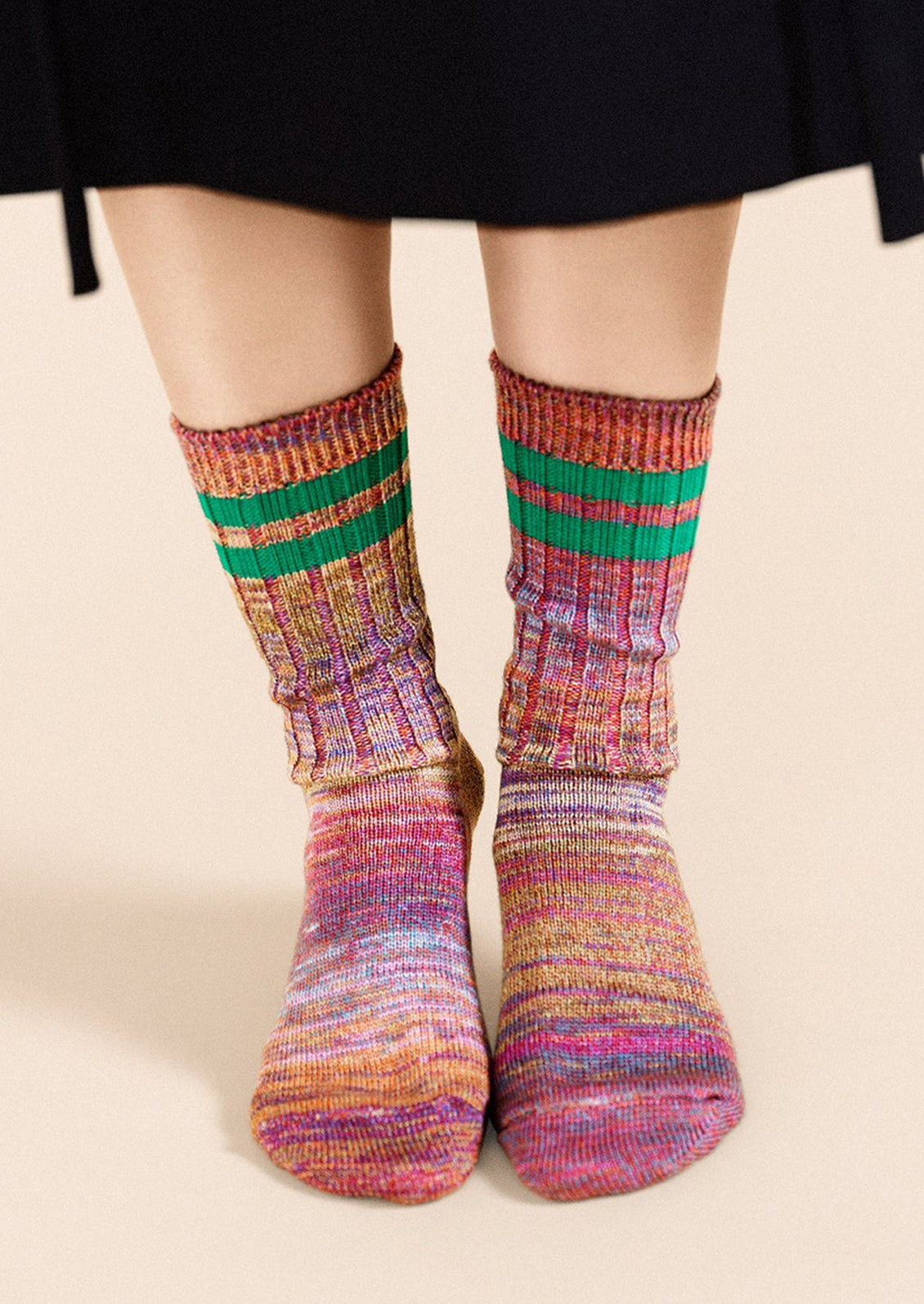 A pair of multicolor space dye socks with double green sporty stripe detail.