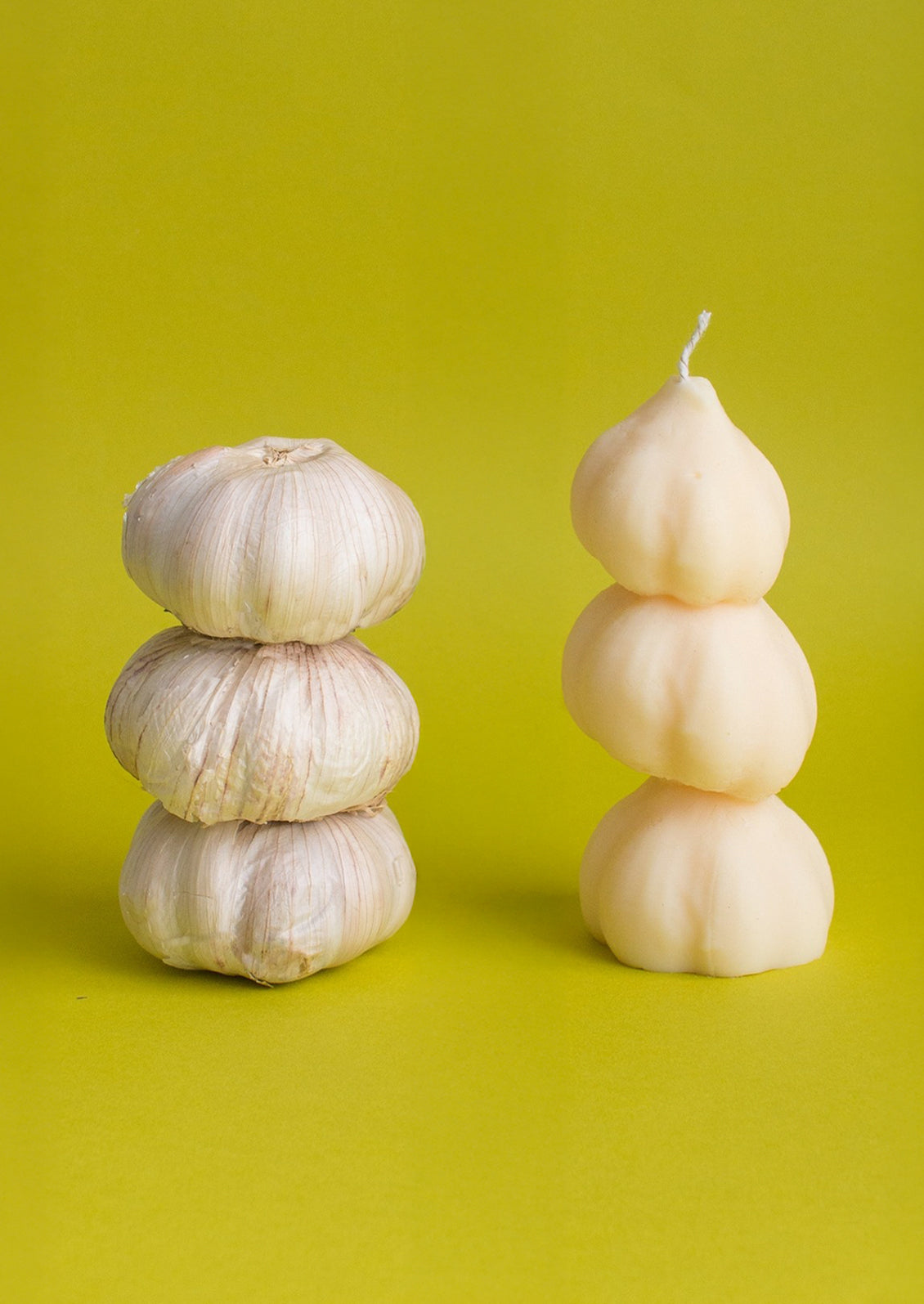A candle in the shape of three stacked garlic bulbs.