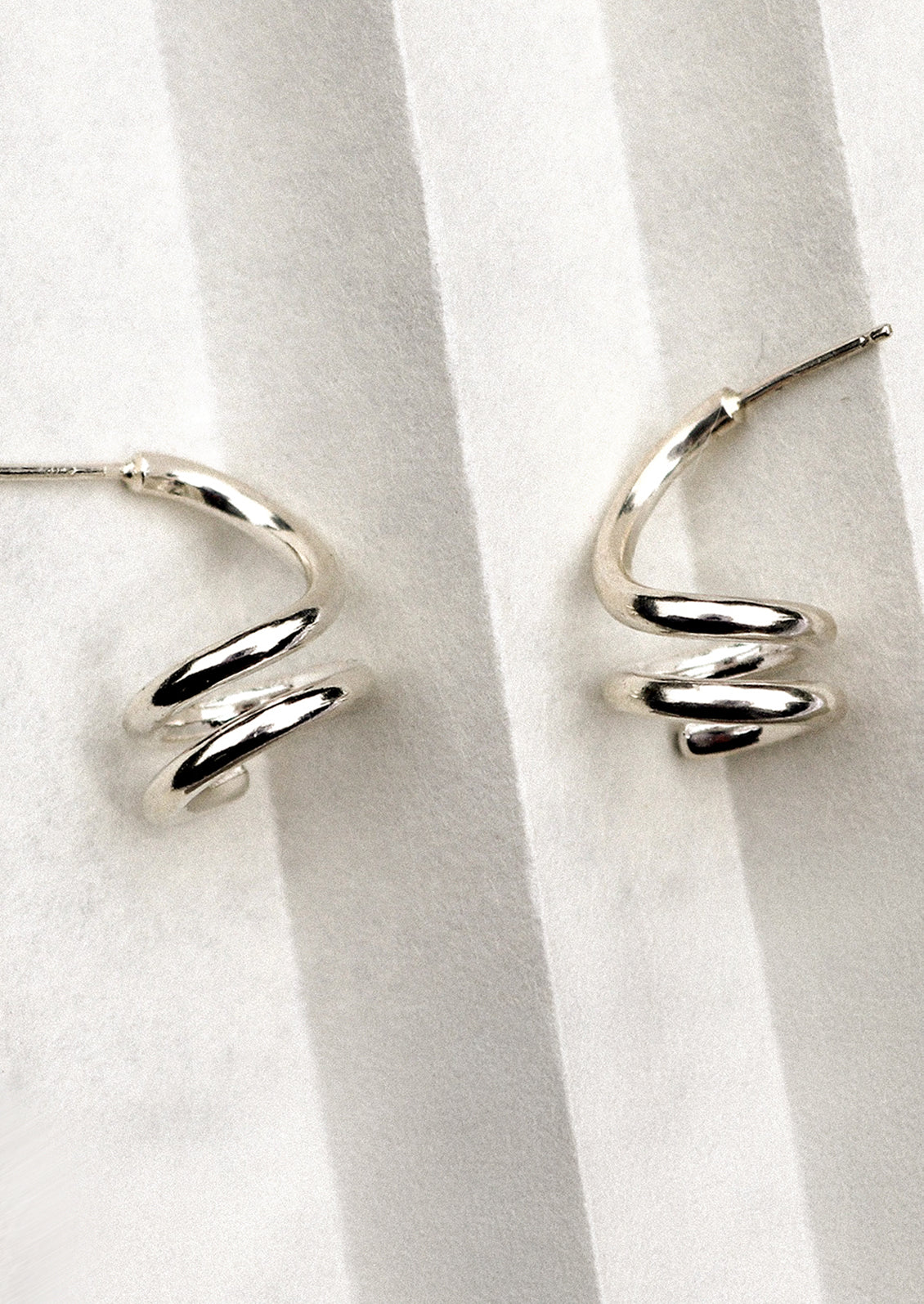 A pair of sterling silver earrings in coil shape.