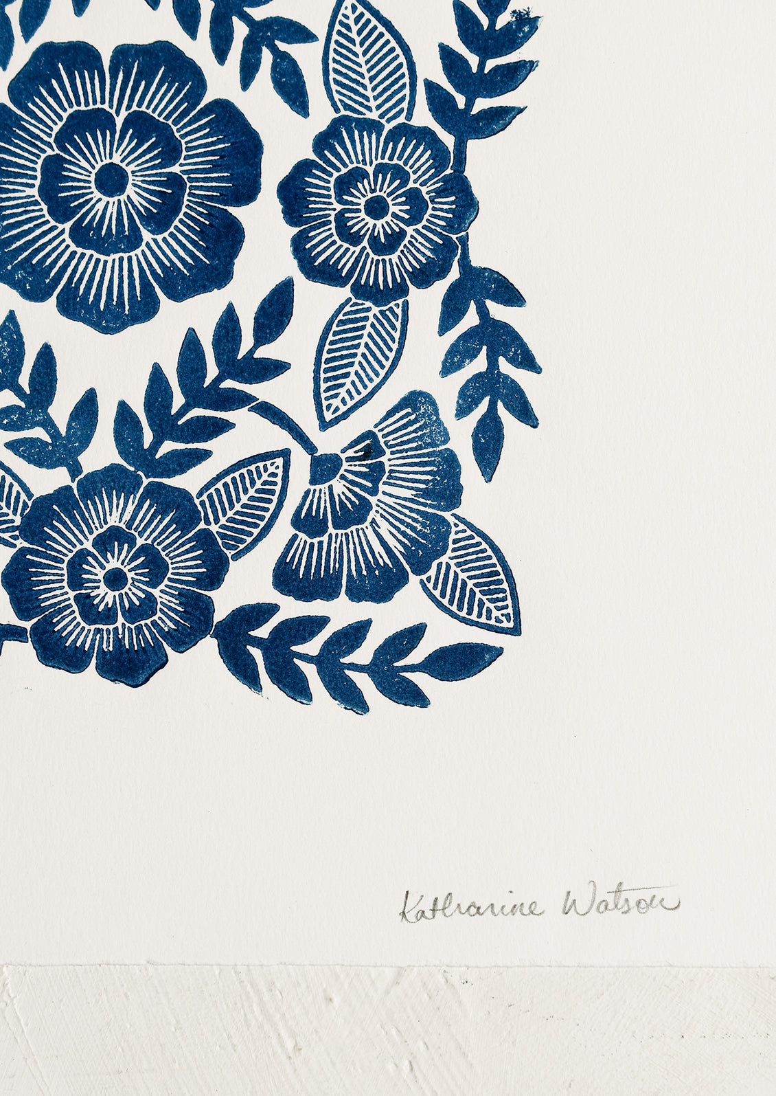 A woodcut floral print block print in indigo ink.
