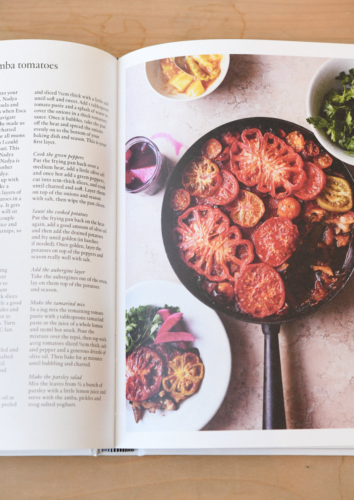 An open cookbook showing a recipe with tomatoes.