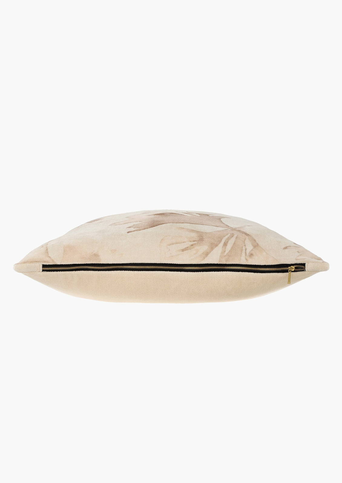 A velvet pillow with exposed black trim metal zipper.