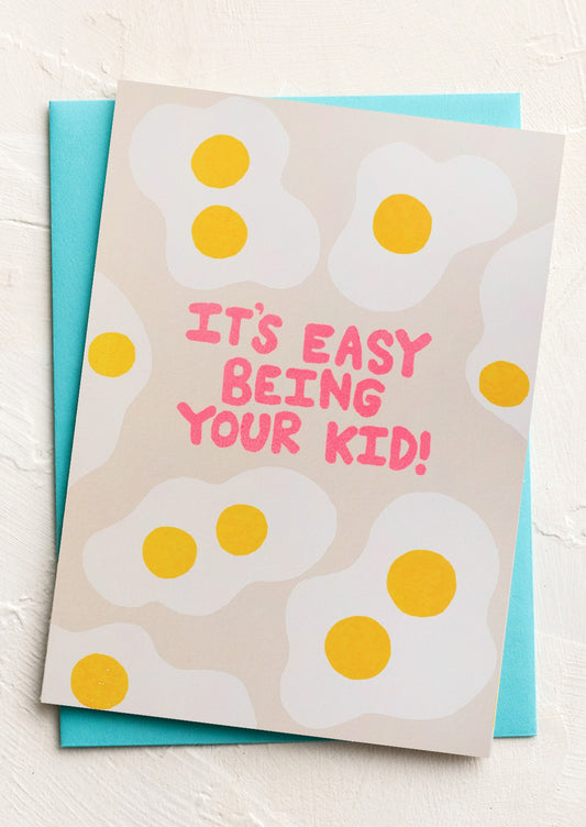 Card with cartoon eggs and text 'It's easy being your kid!' on a white background