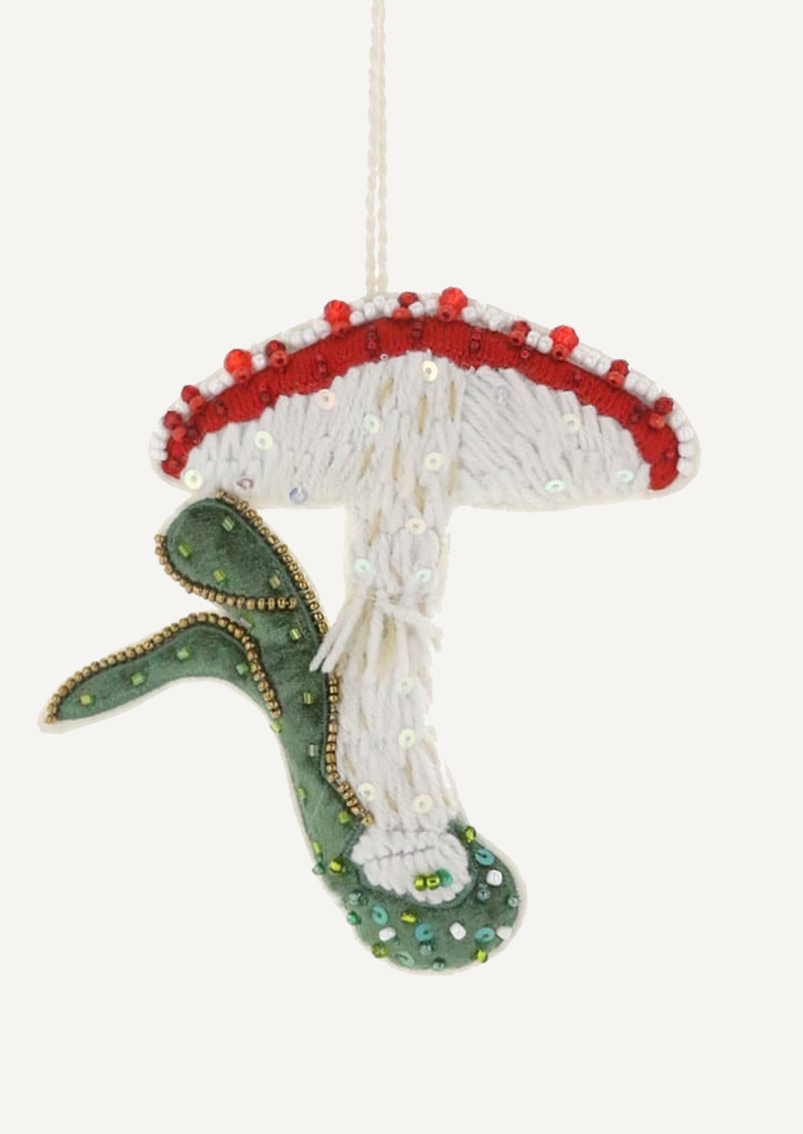 A fabric ornament embroidered in the image of red capped mushroom.