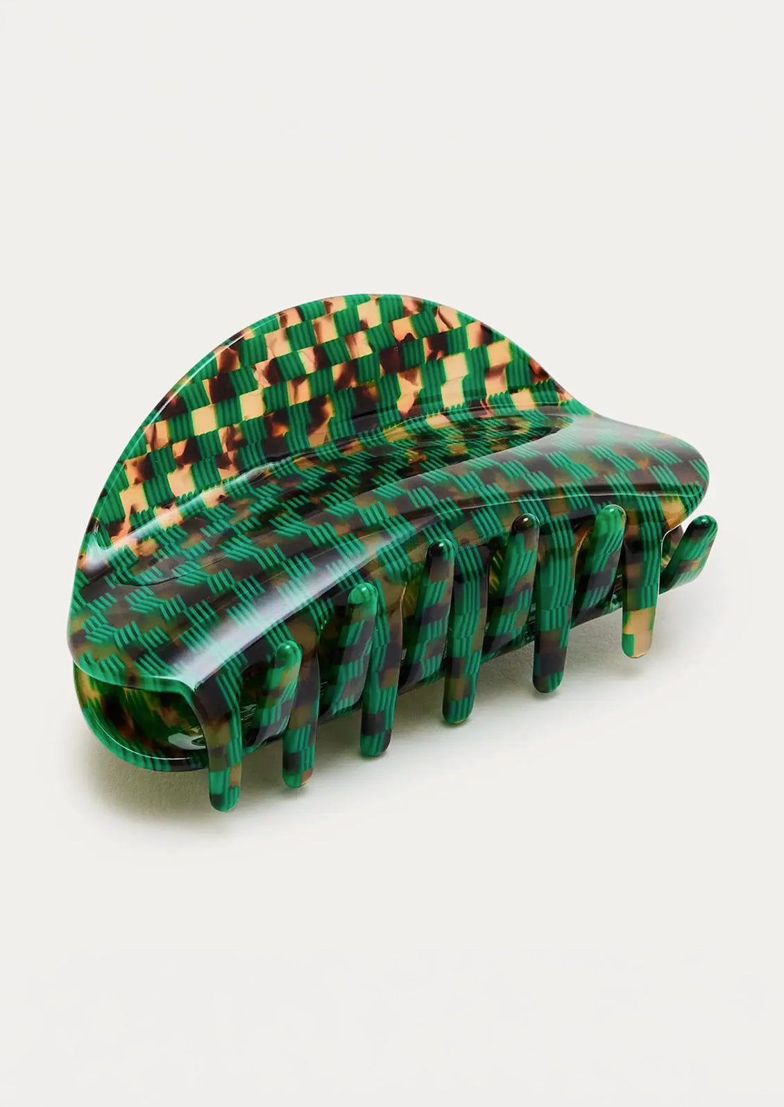 A hair claw with an emerald green checkerboard pattern mixed with a tortoise shell design.