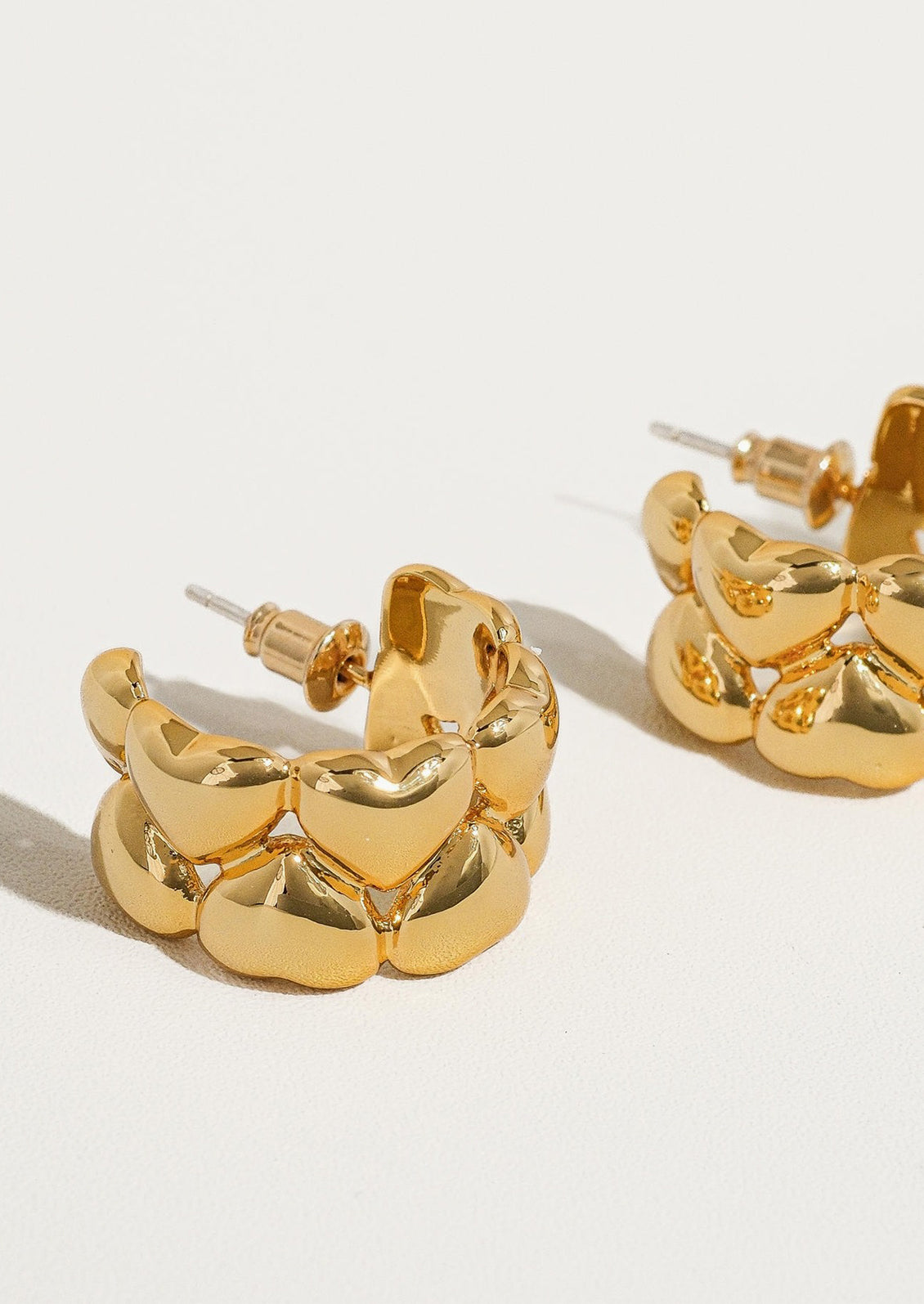 Hoop earrings composed of multiple hearts.