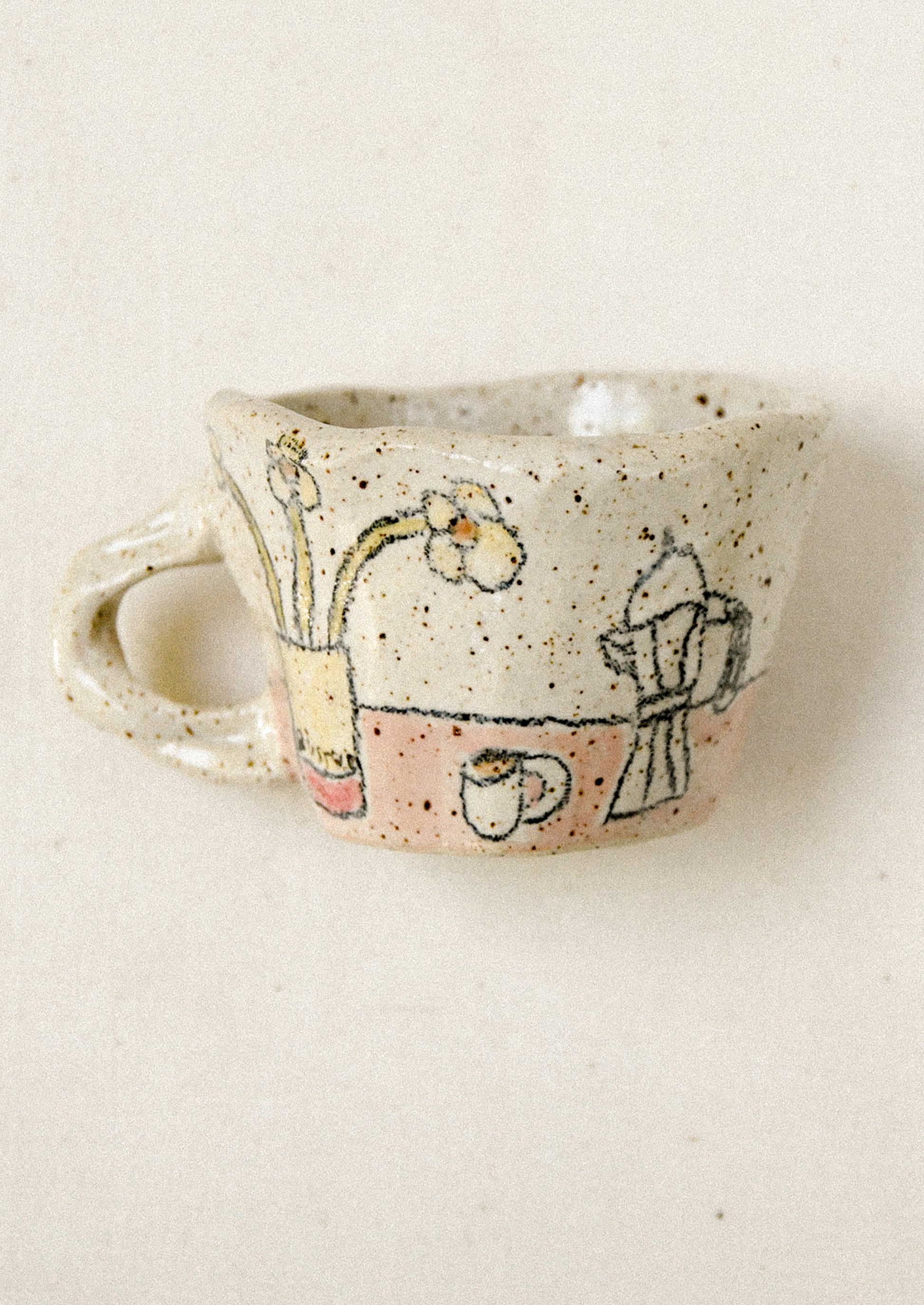 Small ceramic cup with hand-painted designs on a beige background