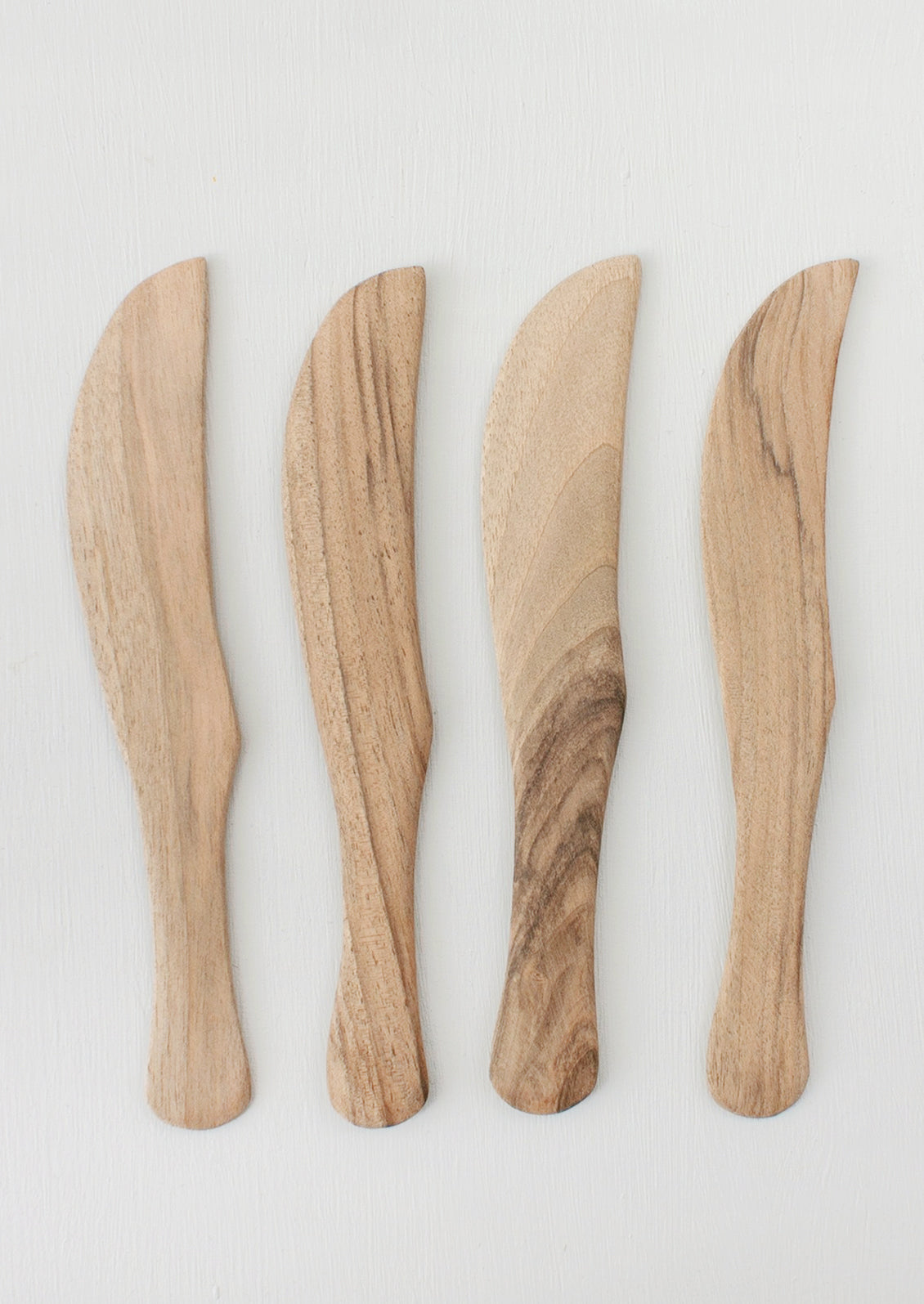 Assorted walnut wood cheese knives.