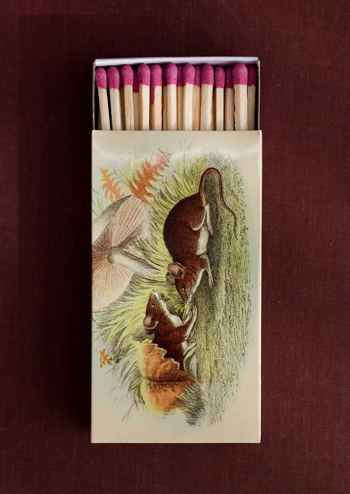 A printed, sliding matchbox with vintage style illustration of mice with mushroom.