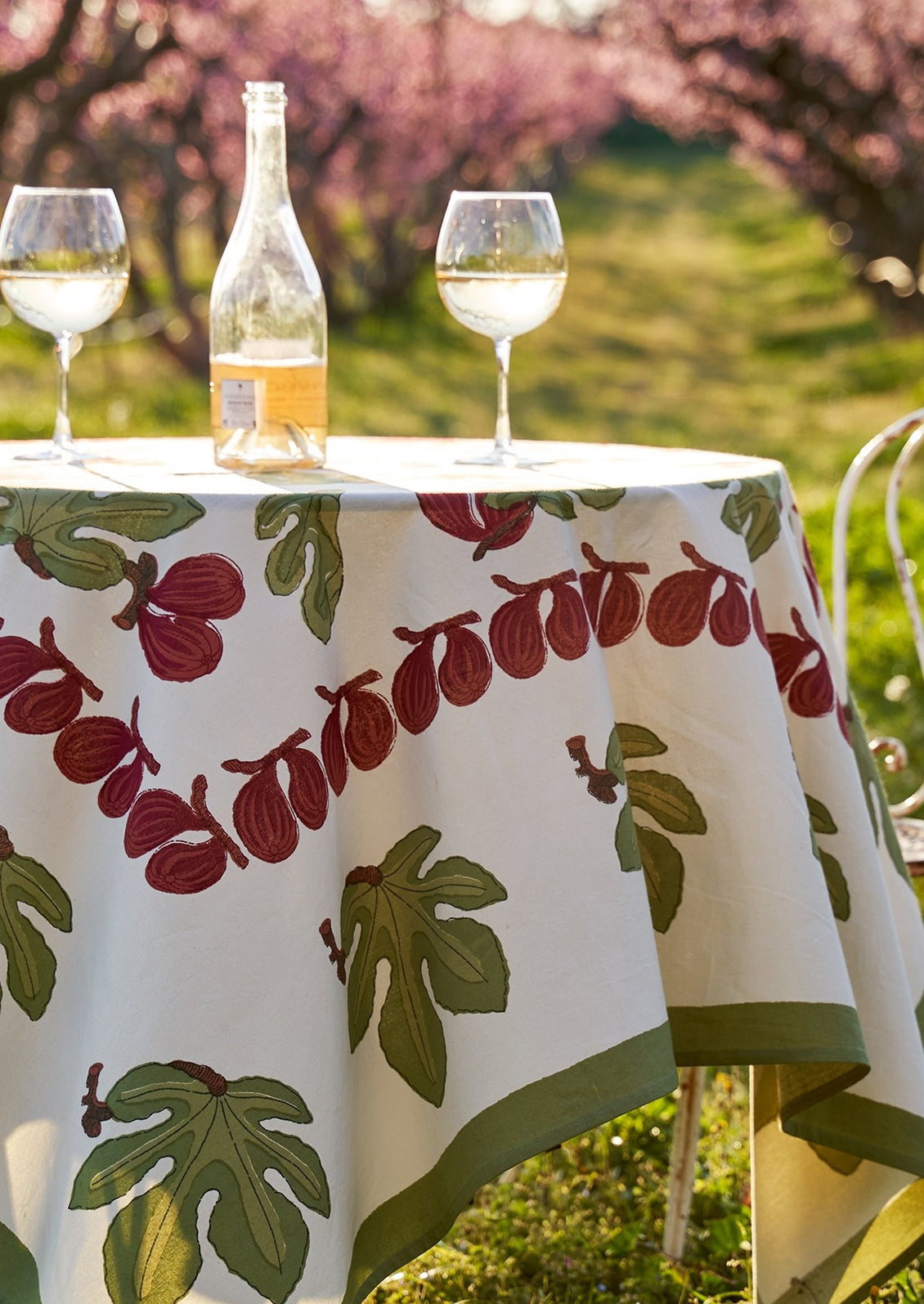 A block printed tablecloth with fig fruit and leaf pattern.
