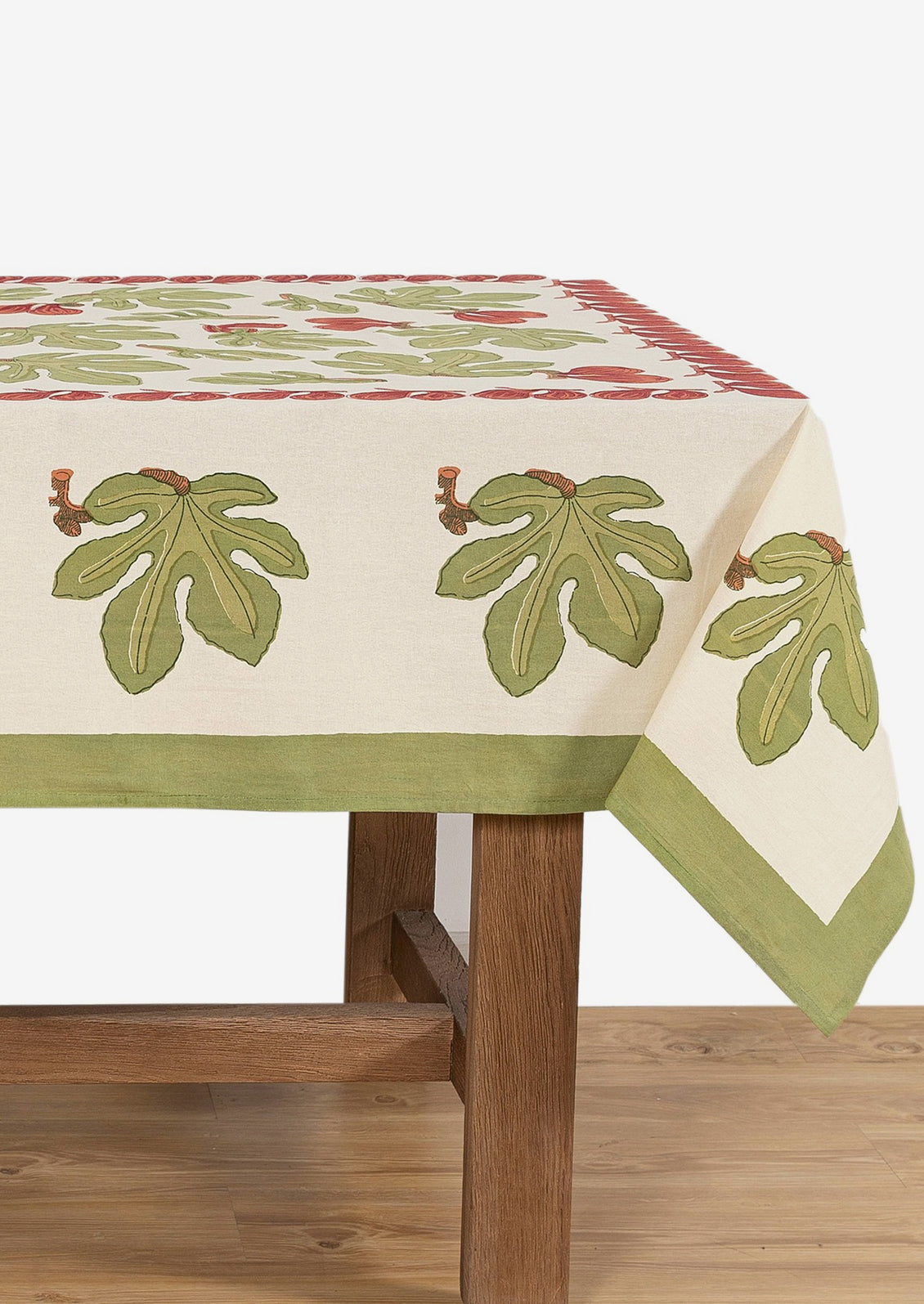 A block printed tablecloth with fig fruit and leaf pattern.
