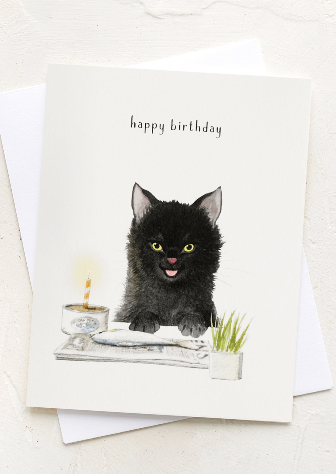A card with illustration of cat eating a fish, text reads "happy birthday".
