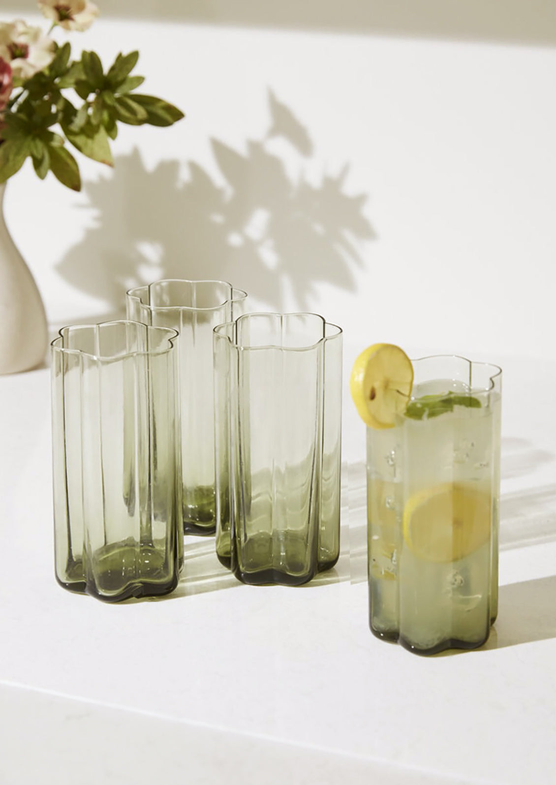Flower shaped water glasses in natural recycled glass.