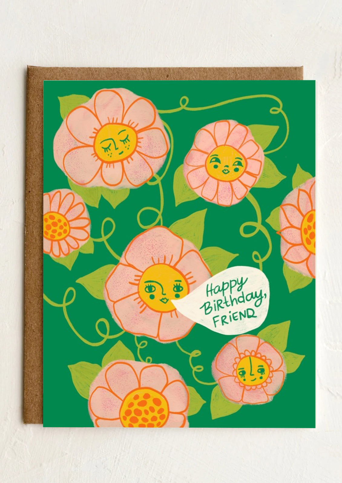 A card illustrated with flowers with faces, one of them has a speech bubble reading "Happy birthday friend".