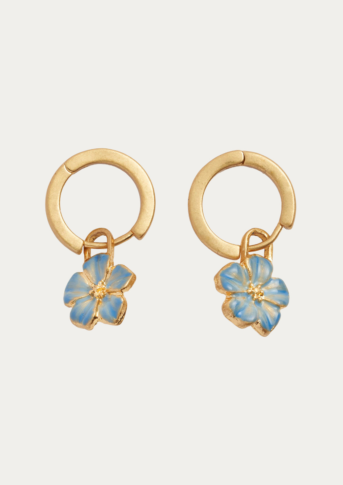 A pair of gold hoops with blue forget me not flower charms.