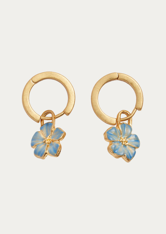 A pair of gold hoops with blue forget me not flower charms.