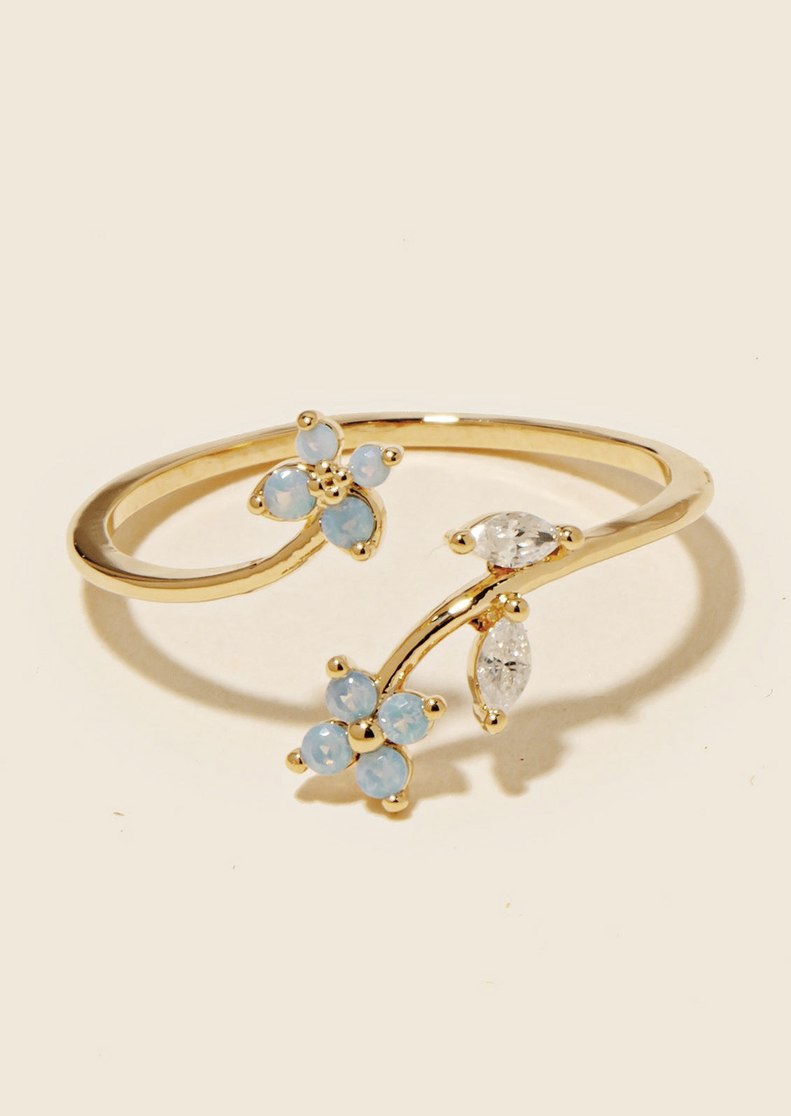 An open ring with blue crystal flowers and clear crystal leaves.