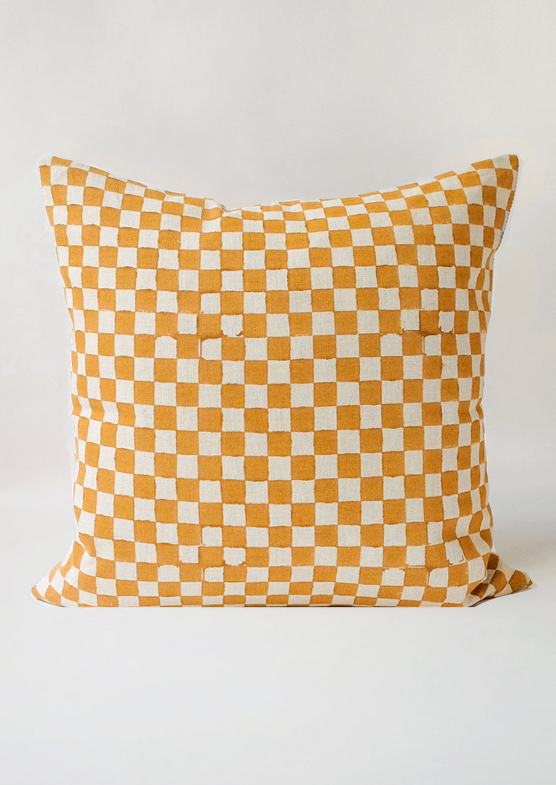 The reverse side of a square pillow with mustard checker print.