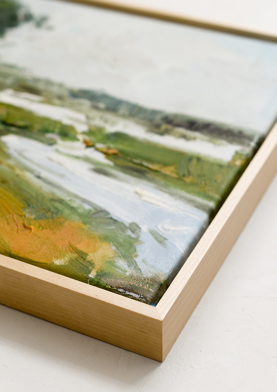 An original landscape oil painting in maple frame.