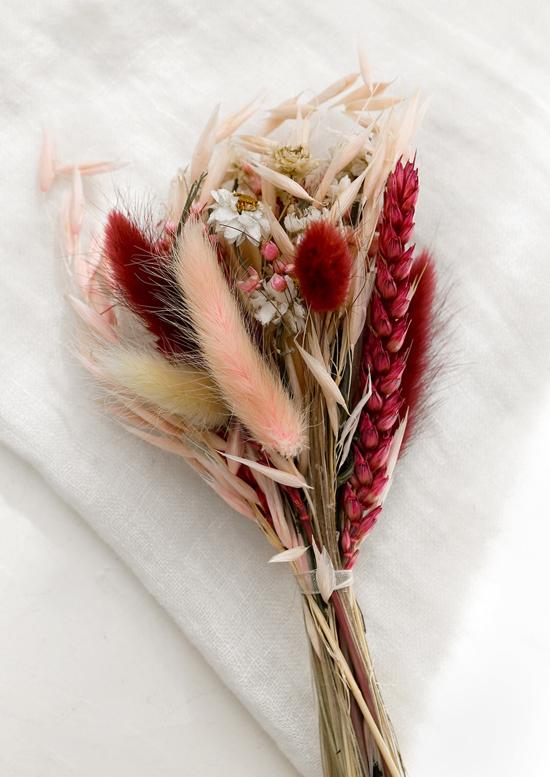 A dried bundle of flowers in maroon multi.