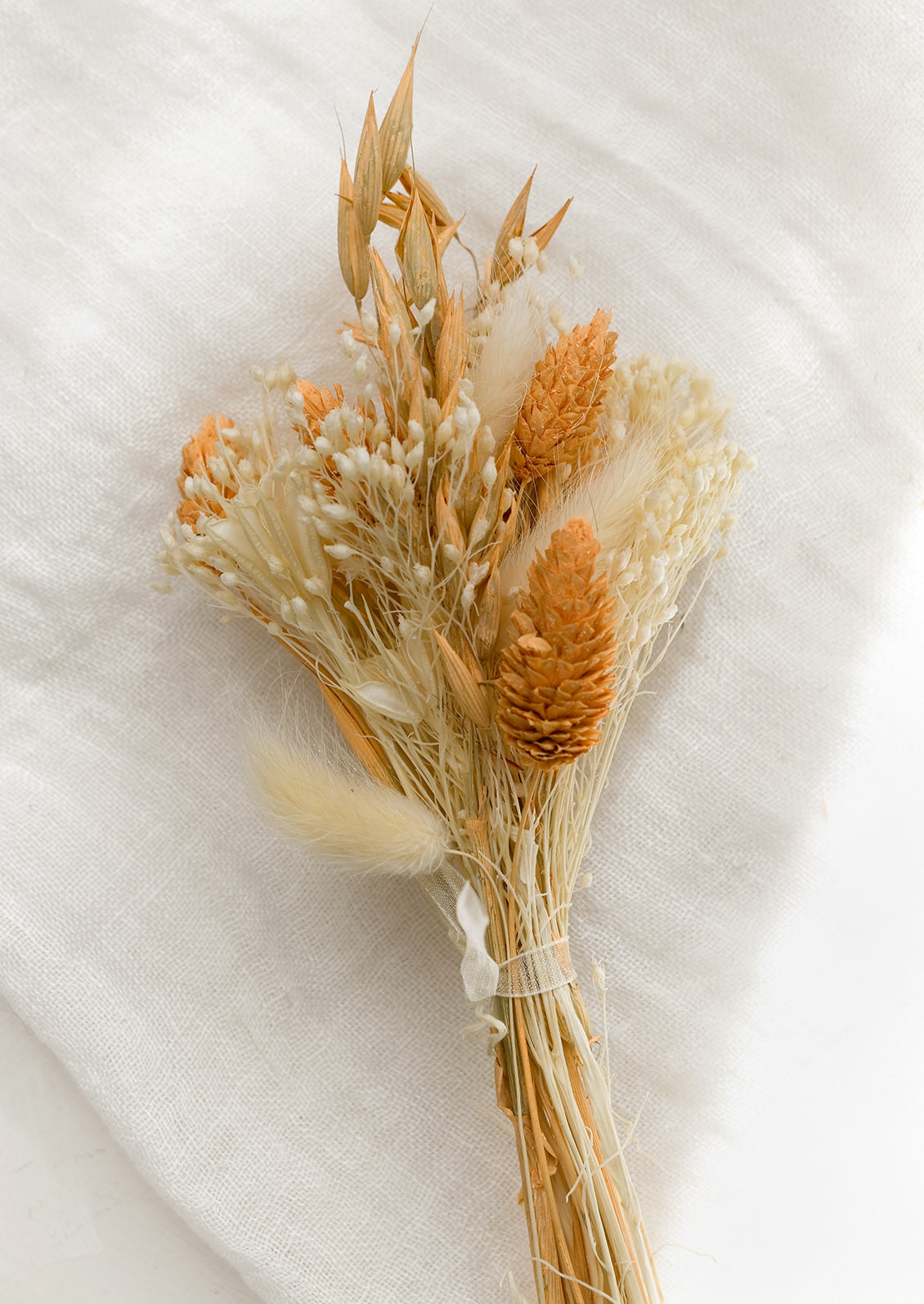 A dried bundle of flowers in peach multi.