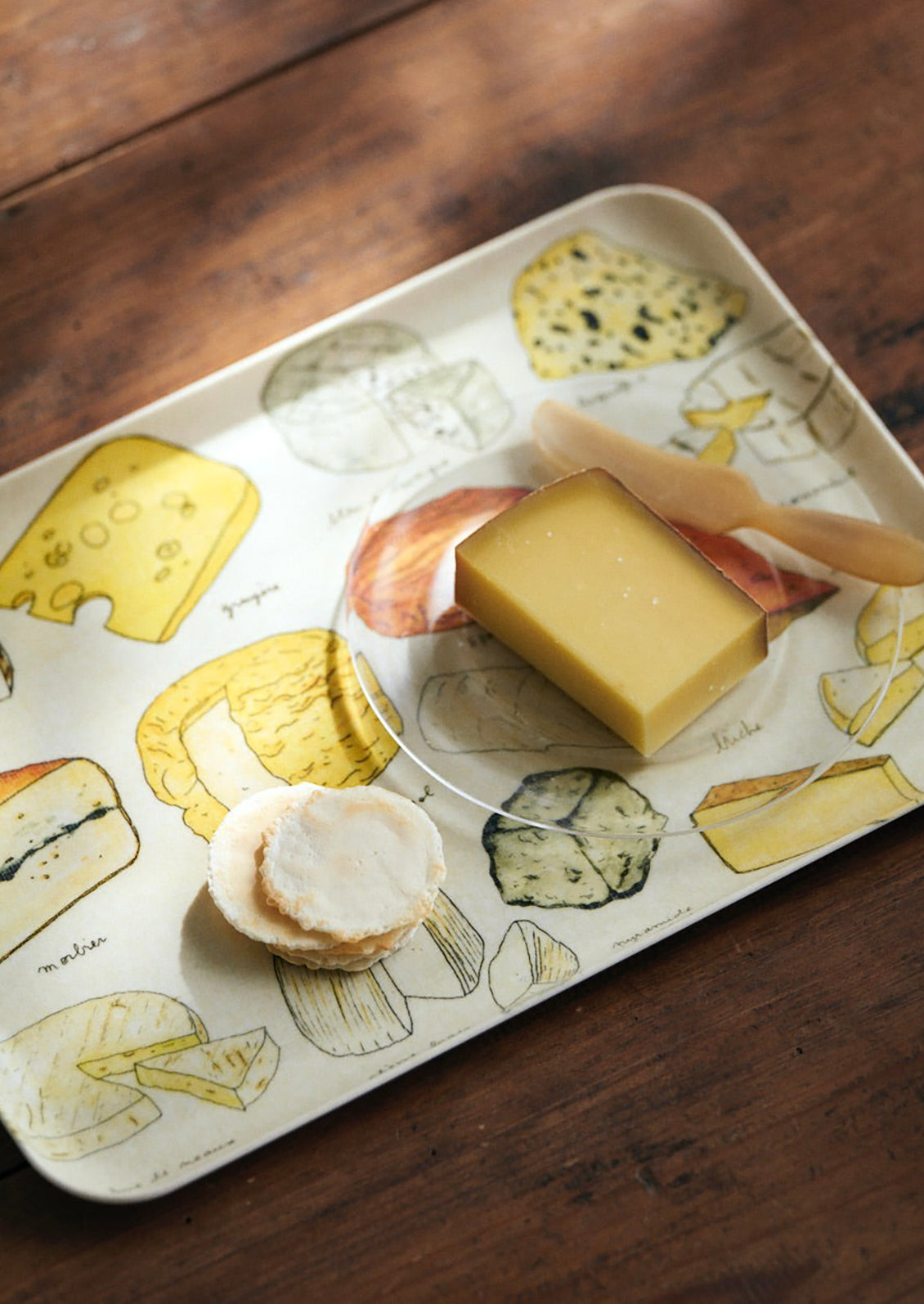 A serving tray with cheese print.