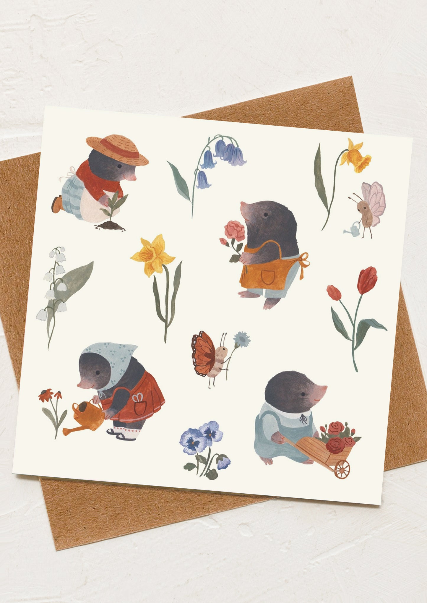 A greeting card with illustration of moles doing gardening activities.
