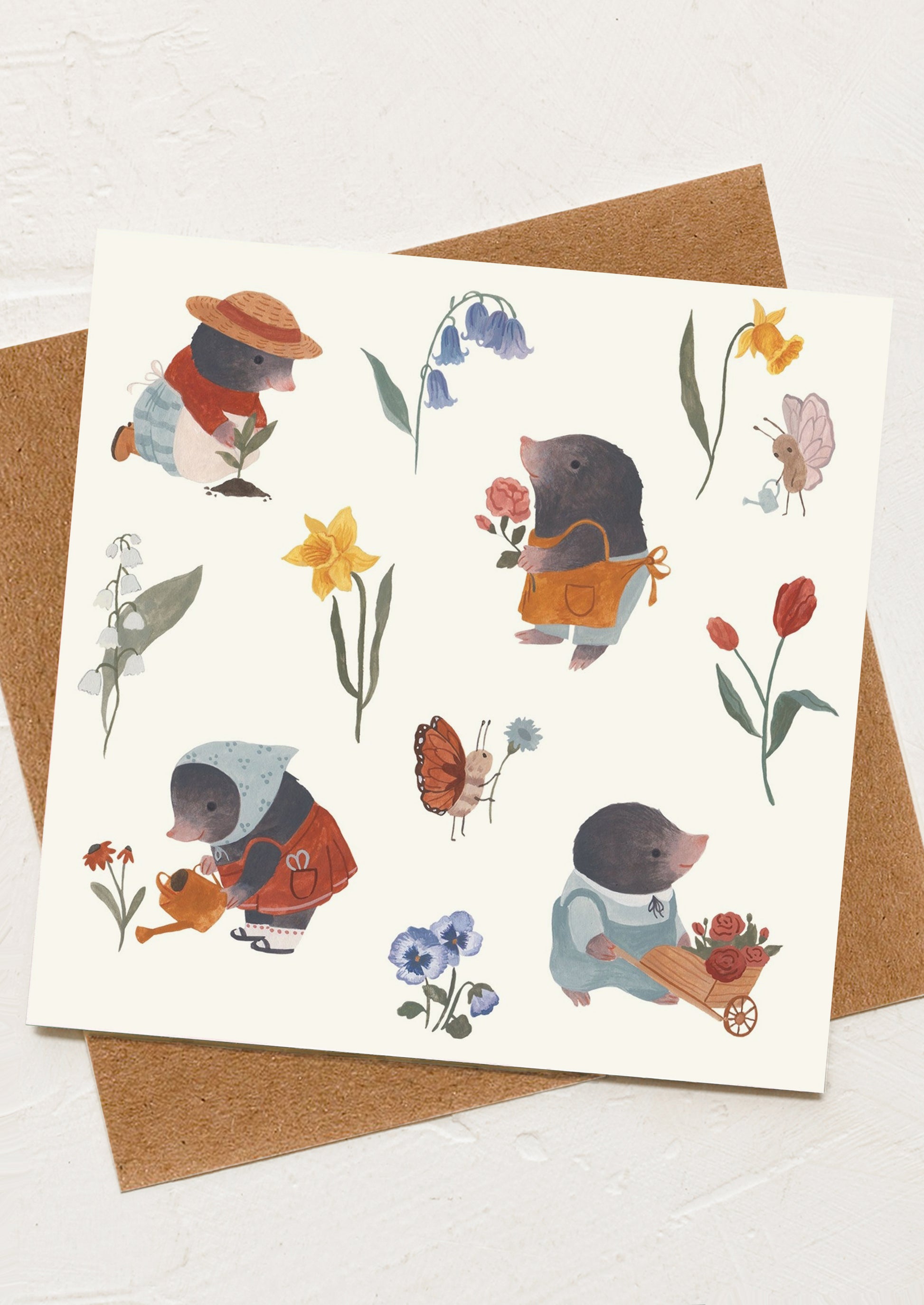 A greeting card with illustration of moles doing gardening activities.