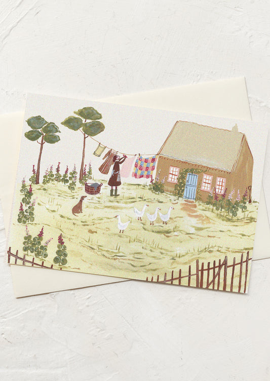 A greeting card with illustration of cottage scene with person, dog and geese.