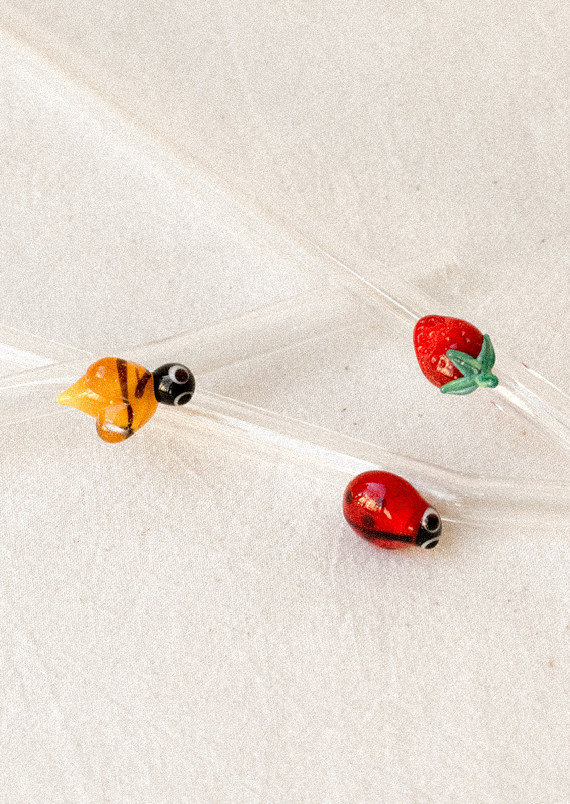 Clear glass straws with bend shape, with assorted figurine detailing.