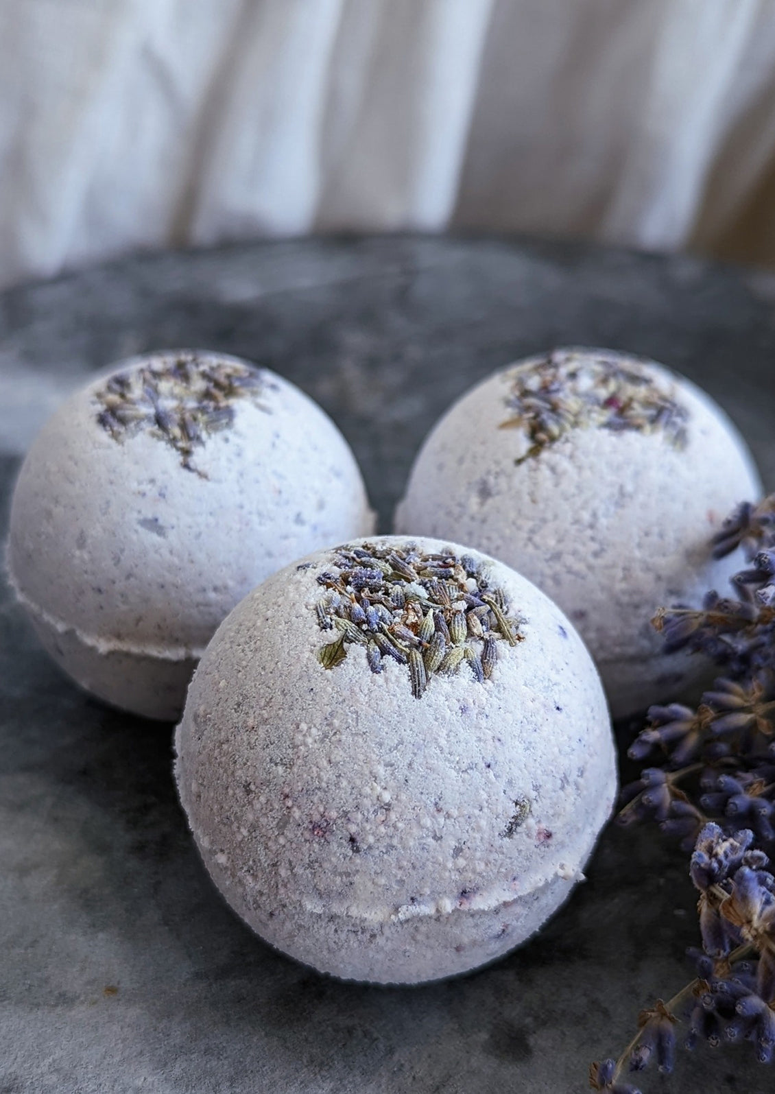 Purple bath bombs with lavender buds.