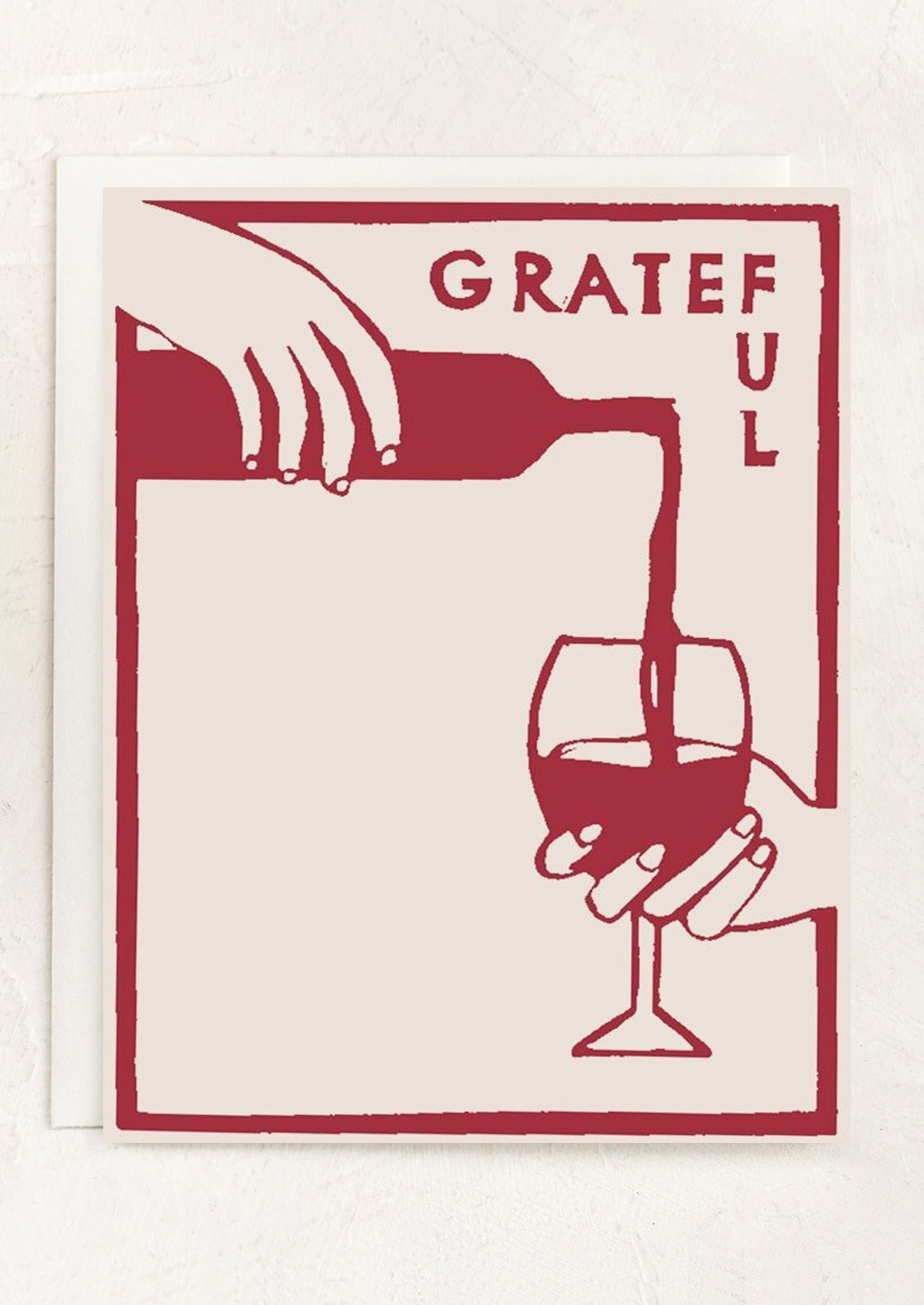 Card with red illustration of a hand pouring wine into a glass, accompanied by the word 'GRATEFUL'.