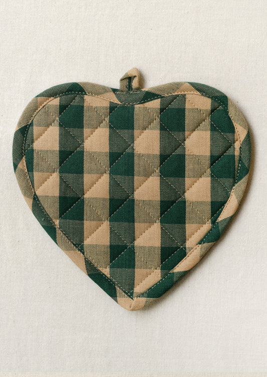 A heart shaped pot holder with a green and tan gingham pattern.