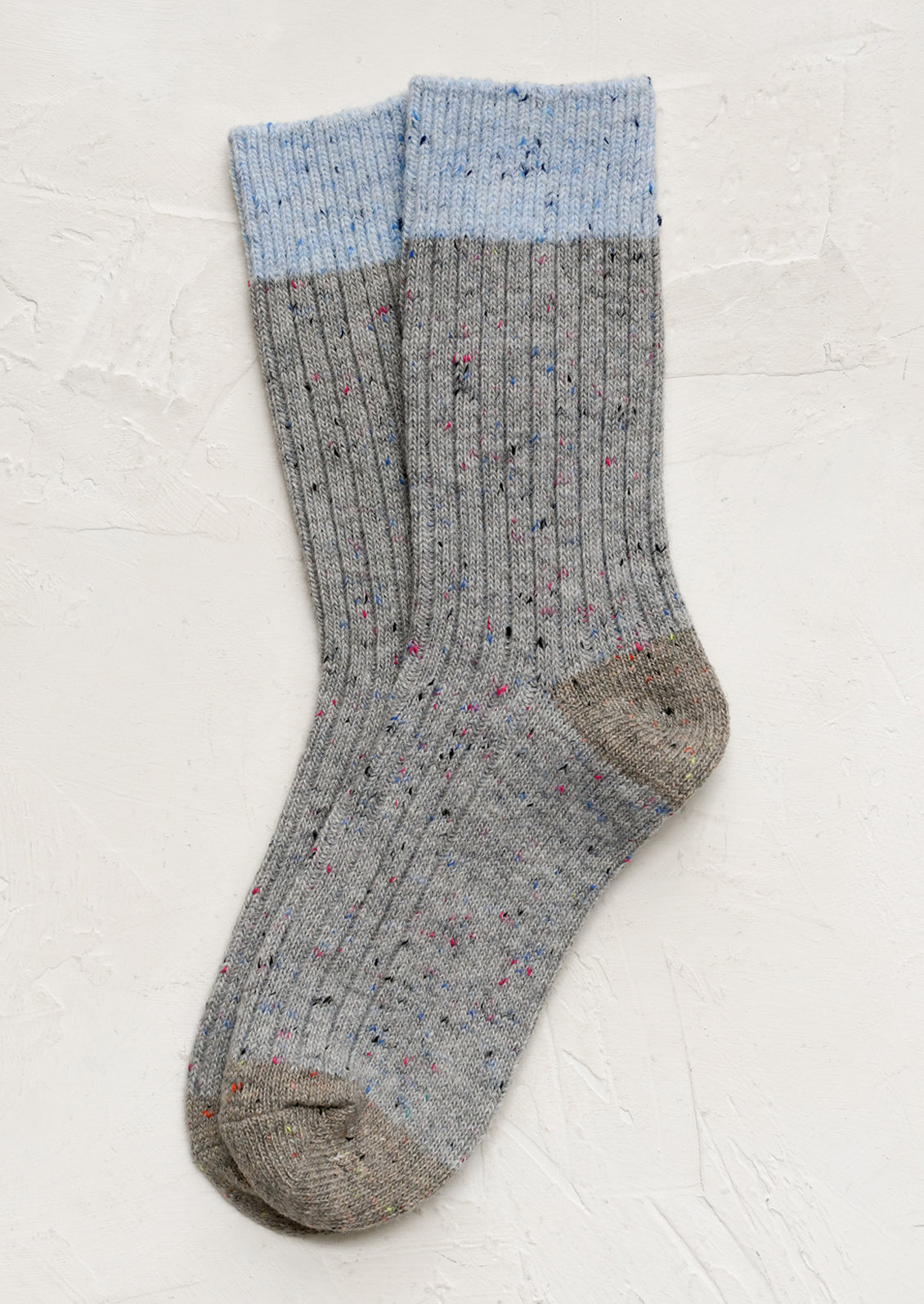 A pair of grey socks with blue contrast.