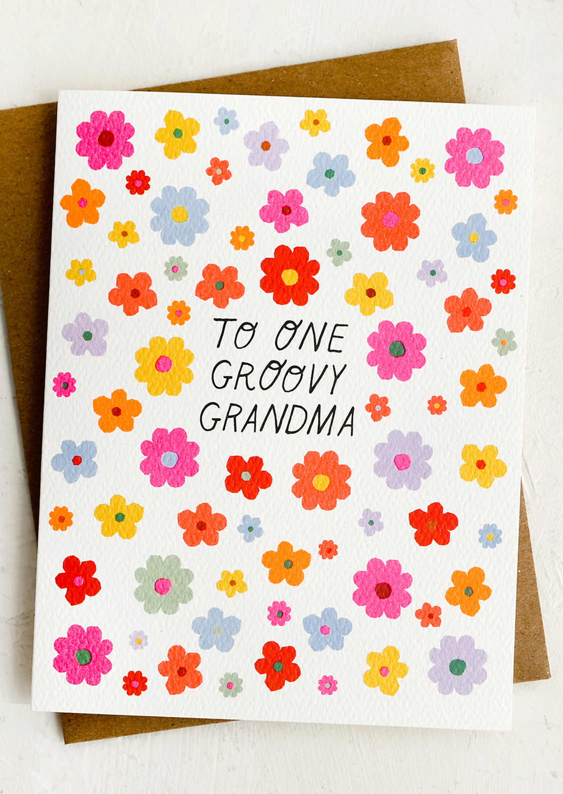 Neon floral print card reading "To one groovy grandma".