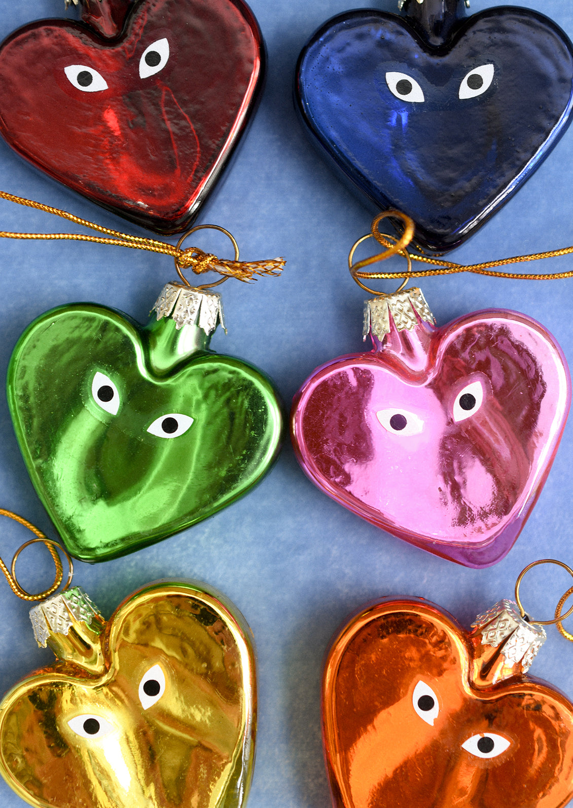Heart shaped glass ornaments in different colors with eyeball detail.